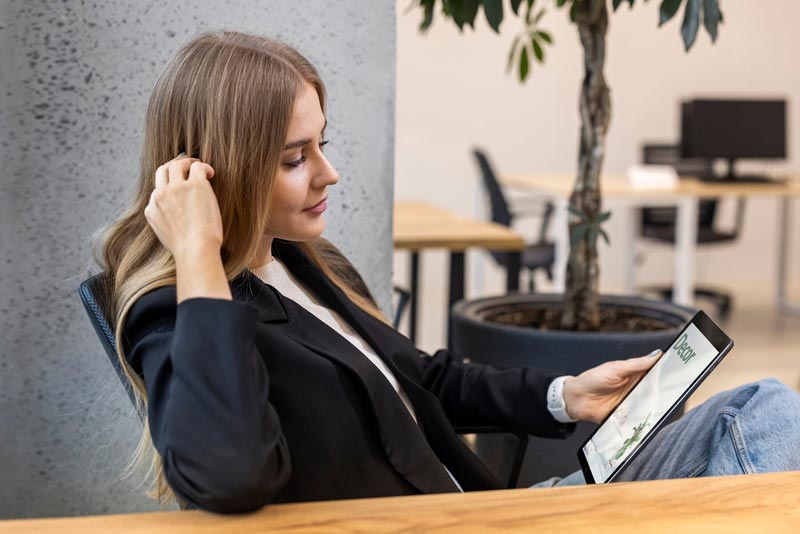 A businesswoman in Sydney taking notes while planning an SEO strategy for her company.