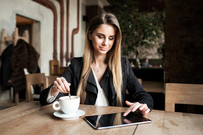 A businesswoman working on an SEO strategy at a café in Macedon, focusing on local search rankings.