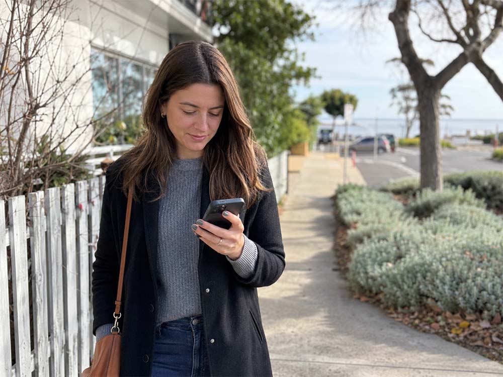 Professional woman using her phone outdoors in Mornington, Melbourne