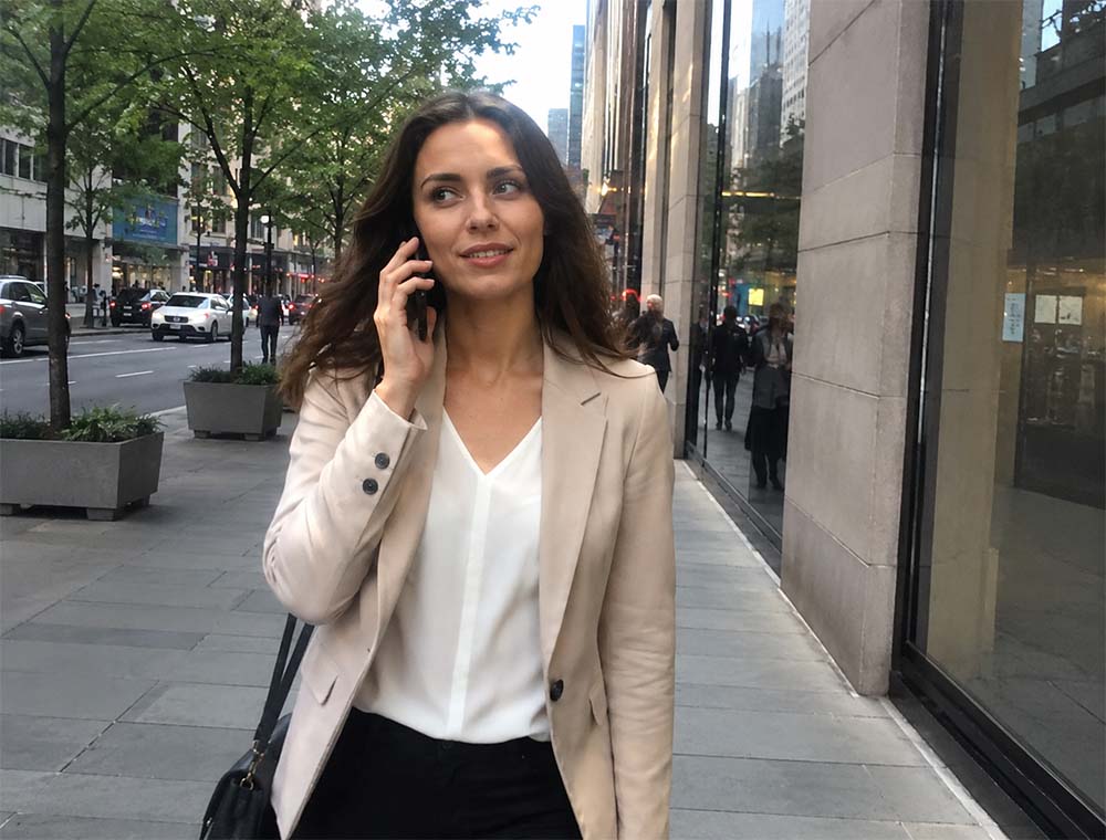 Business woman walking through Melbourne while speaking on the phone about local SEO services.