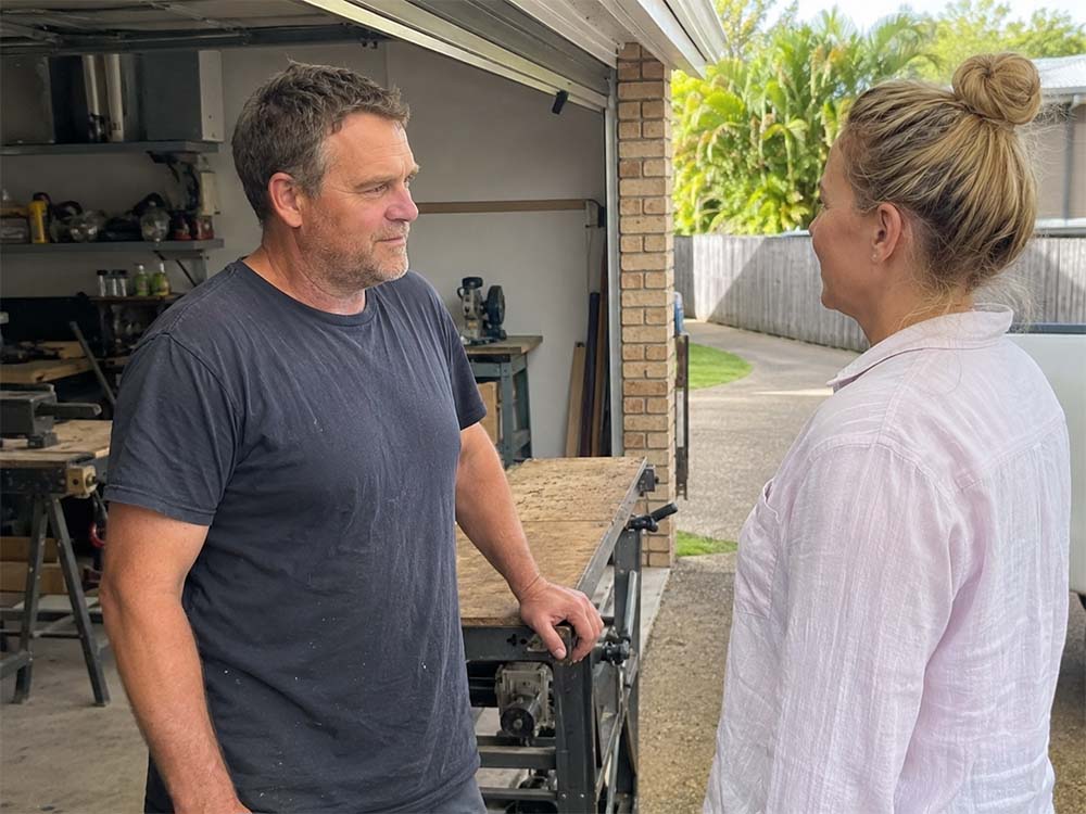 Tradie discussing service options, customer enquiries and local search visibility with a customer