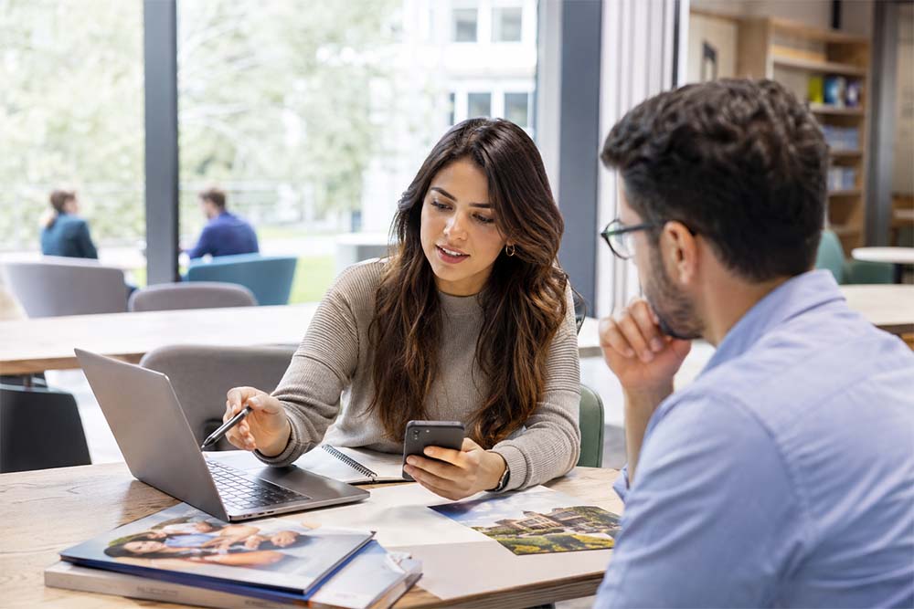 Education marketing meeting with a professional woman planning higher education SEO, course pages and enrolment growth.