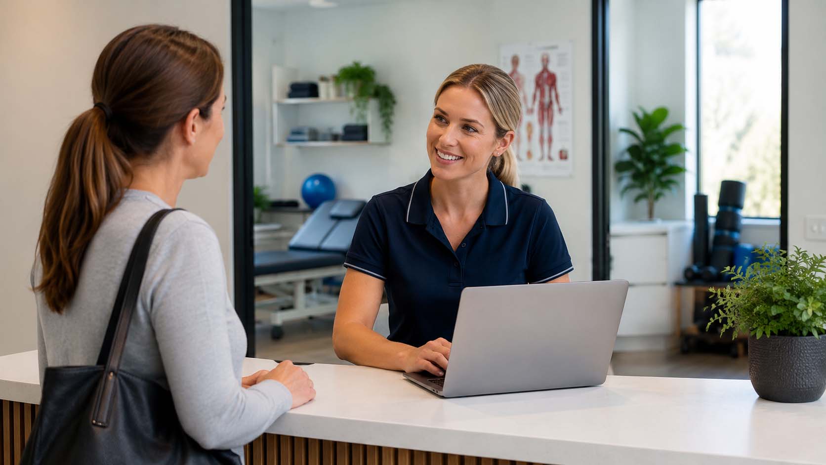 Physio SEO image showing a physiotherapy clinic receptionist speaking with a patient about an appointment booking