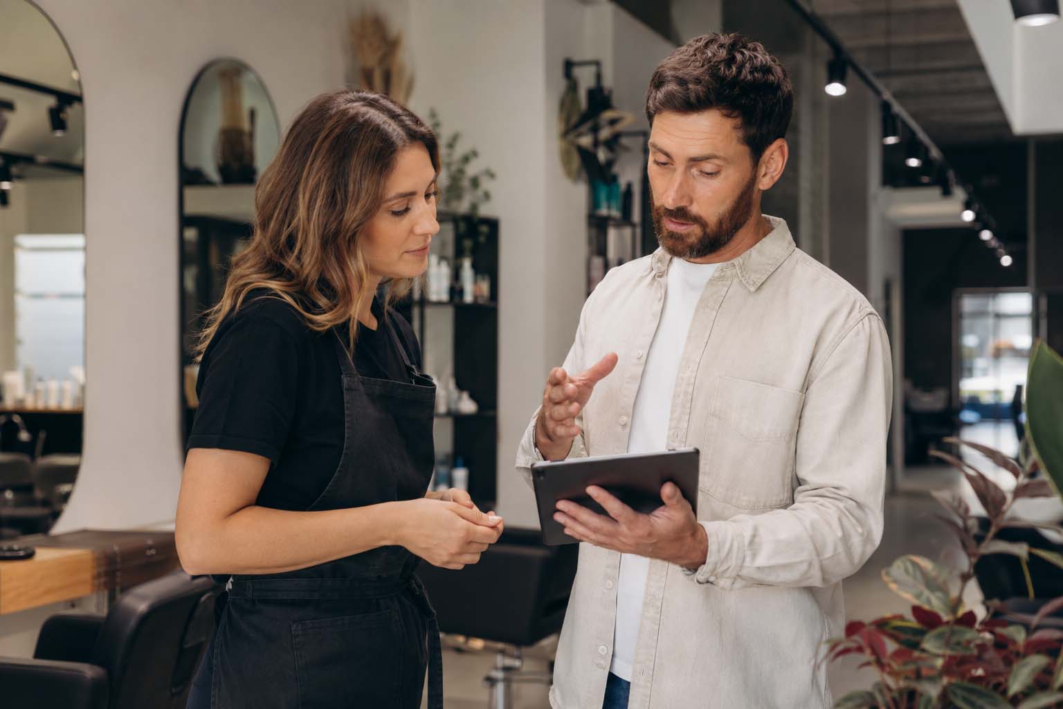 Business owner and consultant discussing what should be included in an SEO service